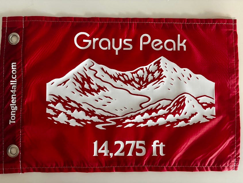 Red flag with mountain design and text on a white background