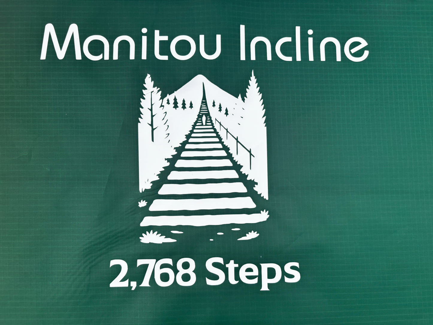 Manitou Incline logo with a stairway illustration and '2,768 Steps' text on a green background.