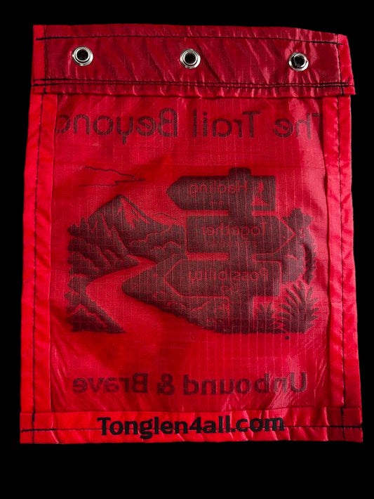 Red bag with text and branding on a textured surface