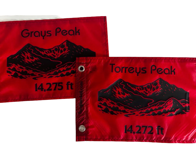 Two red flags with black text and mountain illustrations on a white background