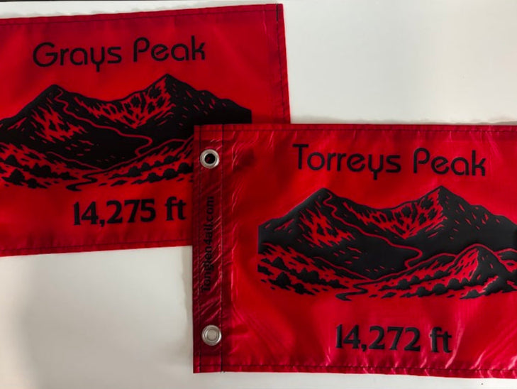Two red flags with black text and mountain illustrations on a white background
