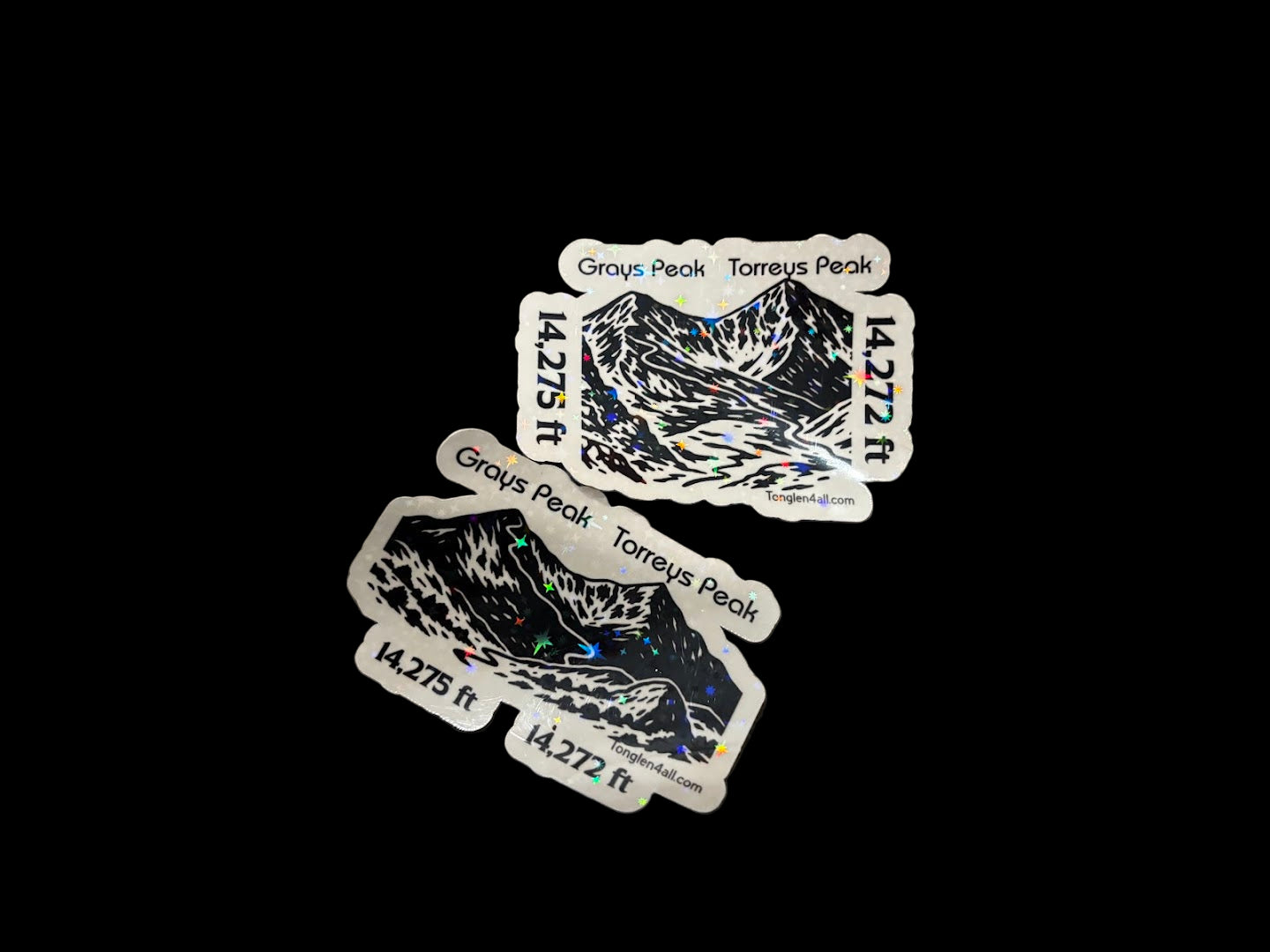 Three stickers with wolf designs on a textured surface