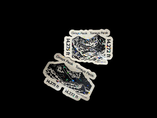 Three stickers with wolf designs on a textured surface