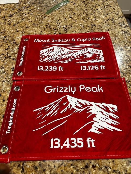 Red flag with mountain peak measurements on a granite surface