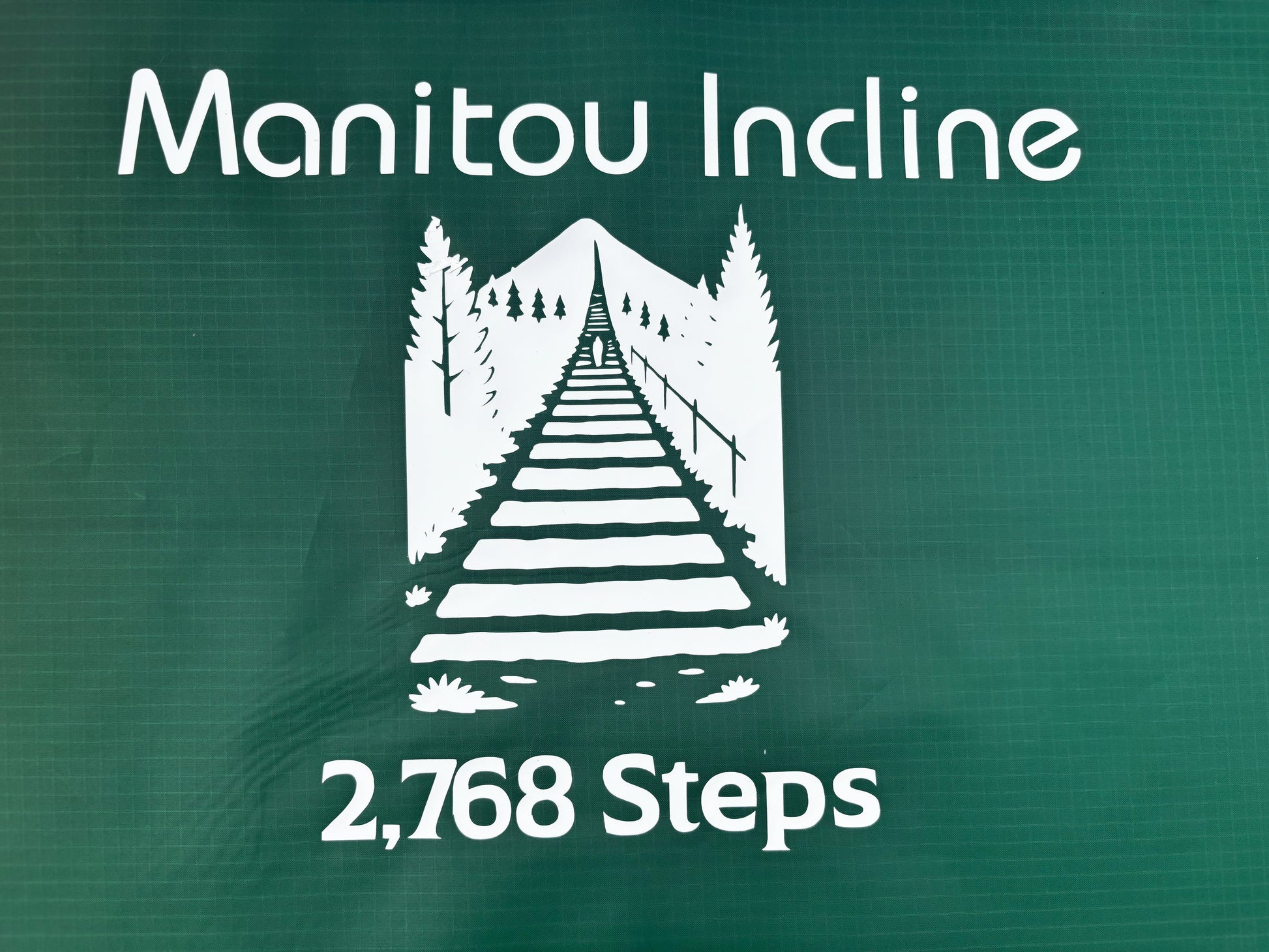Manitou Incline logo with a stairway illustration and '2,768 Steps' text on a green background.