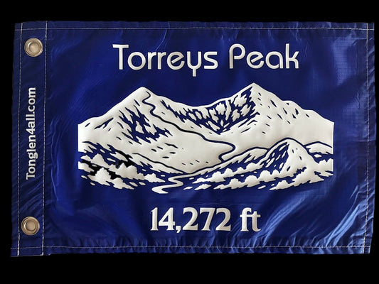 Blue flag with white mountain illustration and text on a beige background