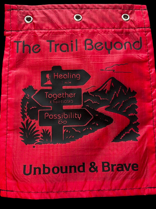 Red bag with black text and graphics on a textured surface